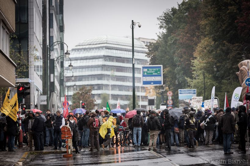 Protestors carry signs and banners during a demonstration outside of an EU summit in  Brussels on Thursday, Oct. 15, 2015. (AP Photo/Valentin Bianchi)